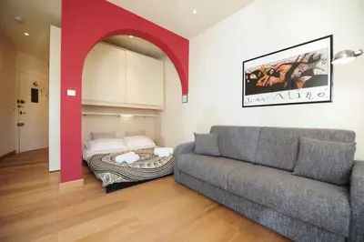 a living room with a couch and a bed at Mini Suite Miro Five Stars Holiday House in Nice
