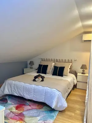 a bedroom with a large bed with a stuffed animal on it at DIEGO 4 pièces duplex in Nice