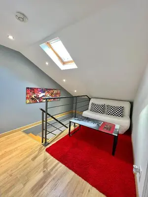 a living room with a couch and a red rug at DIEGO 4 pièces duplex in Nice