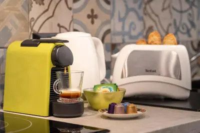 a yellow coffee maker sitting on a counter with a drink at Nice Centre proche Mer Appartement Lumineux 6 Pers Idéal Famille Location éligible au Bail Mobilité Mobility Lease in Nice