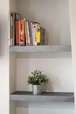 a shelf with books and a potted plant on it at Nice Centre proche Mer Appartement Lumineux 6 Pers Idéal Famille Location éligible au Bail Mobilité Mobility Lease in Nice