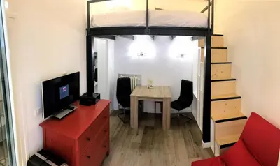 a bedroom with a bunk bed and a table at STUDIO DECO DESIGN, HYPER CALME in Nice