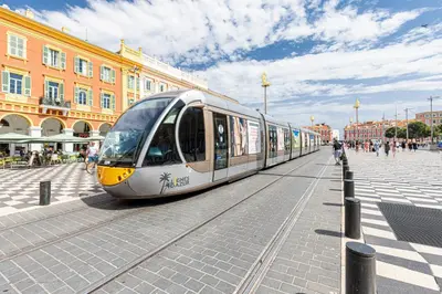 a train on the tracks in a city at COCOON BEACH Central Proche Mer in Nice