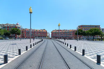a street with train tracks in front of buildings at COCOON BEACH Central Proche Mer in Nice