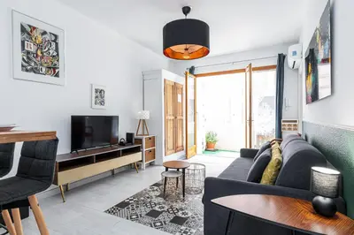 a living room with a couch and a tv at COCOON BEACH Central Proche Mer in Nice