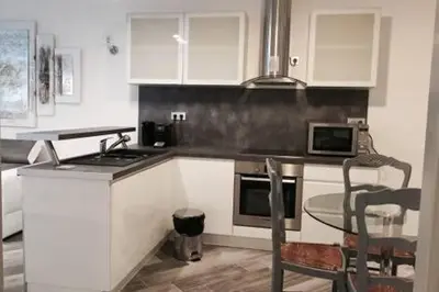a kitchen with a stove and a table with a microwave at Beautiful apartment Rue De La Croix Vieux Nice in Nice