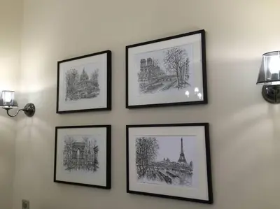 a group of framed pictures on a wall at Beautiful apartment Rue De La Croix Vieux Nice in Nice