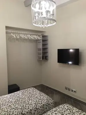 a bedroom with a bed and a chandelier at Beautiful apartment Rue De La Croix Vieux Nice in Nice
