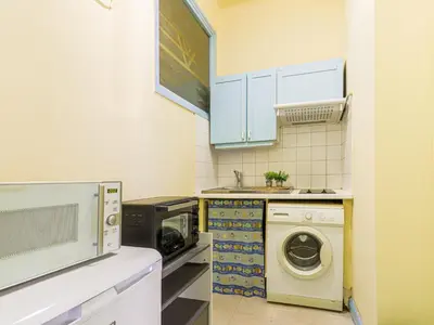 a kitchen with a washing machine and a washer at Apartment Les Colisées by Interhome in Nice