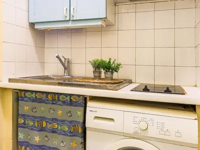 a kitchen with a sink and a washing machine at Apartment Les Colisées by Interhome in Nice