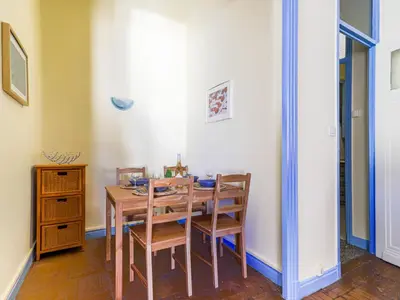 a dining room with a wooden table and chairs at Apartment Les Colisées by Interhome in Nice