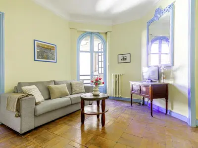 a living room with a couch and a piano at Apartment Les Colisées by Interhome in Nice
