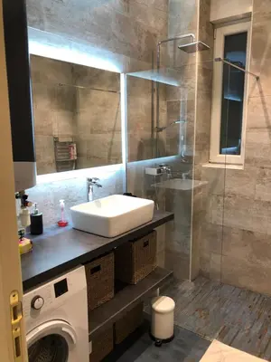 a bathroom with a sink and a glass shower at California in Nice