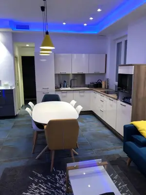 a kitchen with a table and chairs in a room at California in Nice