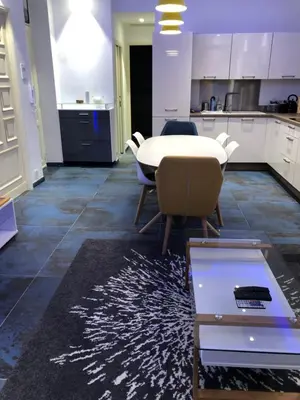 a room with a table and chairs and a kitchen at California in Nice