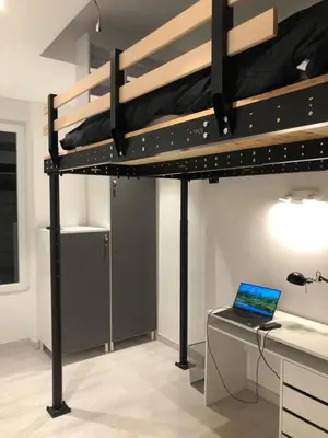 a bedroom with a bunk bed with a laptop on a desk at California in Nice