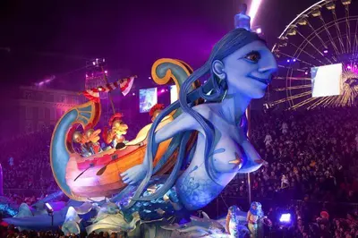 a mermaid in front of a crowd at a carnival at Appartement Les Plages in Nice