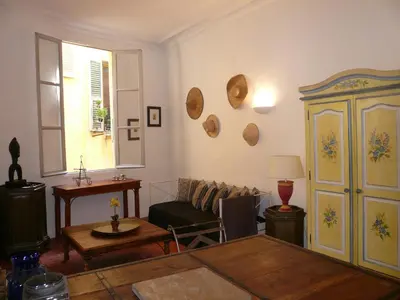 a living room with a couch and a table at Appartements Vieux Nice / Marché aux fleurs in Nice