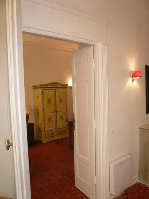 a door leading into a room with a yellow cabinet at Appartements Vieux Nice / Marché aux fleurs in Nice