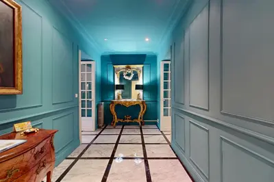 a hallway with blue walls and a chair in a room at Silver Suite Five Stars Holiday House in Nice