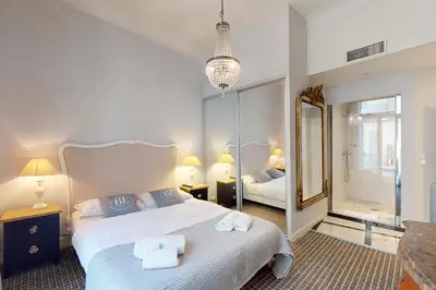 a bedroom with a large bed and a mirror at Silver Suite Five Stars Holiday House in Nice
