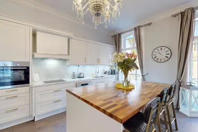 a kitchen with a table and a vase of flowers at Silver Suite Five Stars Holiday House in Nice
