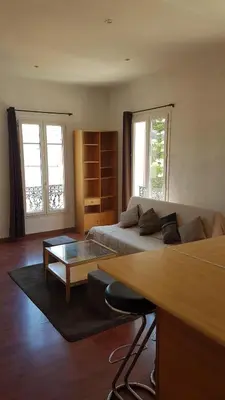 a living room with a couch and a coffee table at Appartement Buenos Aires in Nice