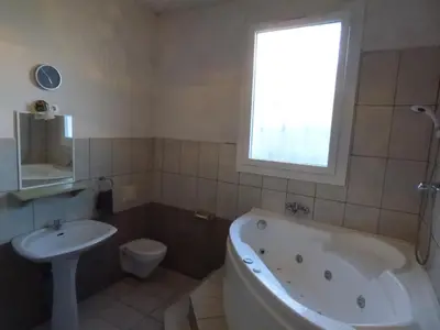 a bathroom with a tub and a toilet and a sink at Appartement Buenos Aires in Nice