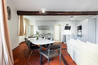 a kitchen and dining room with a white table and chairs at Large 3 Bdr Old Town - AC in Nice