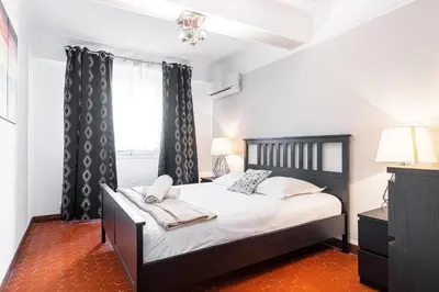 a bedroom with a bed and a window at Large 3 Bdr Old Town - AC in Nice