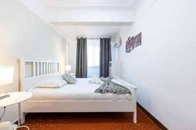 a white bed in a room with a window at Large 3 Bdr Old Town - AC in Nice