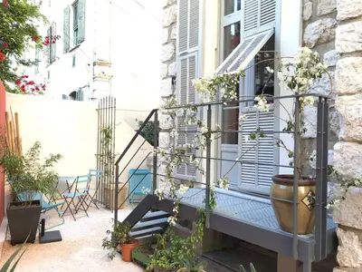 a balcony with stairs and plants on a building at Villa le Nid in Nice