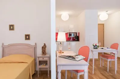 a room with a bed and a table with a tableablish at MEDICIS HOME Nice Saint -Laurent- Du -Var in Saint-Laurent-du-Var