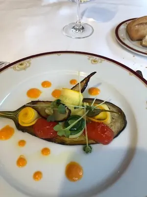 a plate with a piece of food on a table at MEDICIS HOME Nice Saint -Laurent- Du -Var in Saint-Laurent-du-Var
