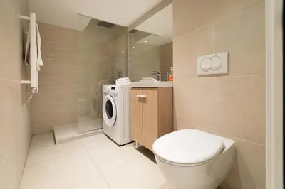 a bathroom with a toilet and a washing machine at Maison Bianchi - Duplex old town in Nice
