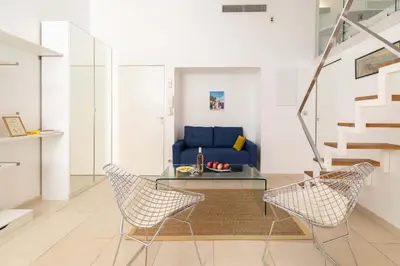 a living room with a blue couch and chairs at Maison Bianchi - Duplex old town in Nice