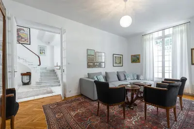 a living room with a couch and a table at Stylish Art Deco villa near the sea 4 Bdrs Pool and garage in Nice