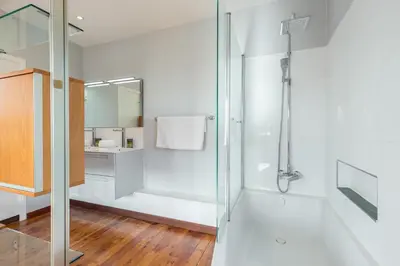 a bathroom with a shower with a glass door at Stylish Art Deco villa near the sea 4 Bdrs Pool and garage in Nice