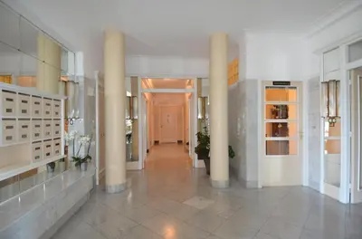 a large hallway with columns in a building at NICE 115 BY THE SEA in Nice