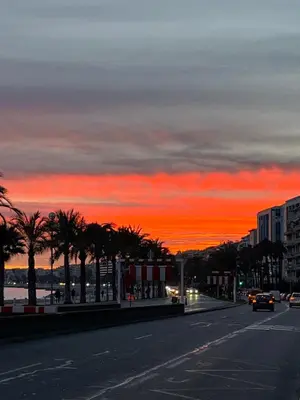 a city street at sunset with a red sky at NICE 115 BY THE SEA in Nice