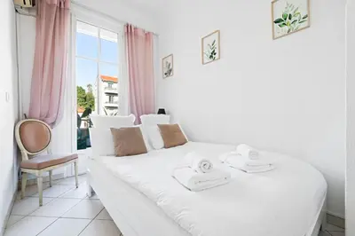 a white bed in a room with a window at Sunlight Properties - 