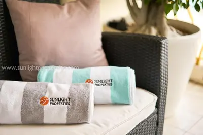 a wicker chair with two towels sitting on it at Sunlight Properties - 
