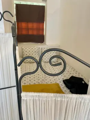 a metal bed with a yellow blanket on it at Super studio in the heart of Nice! in Nice