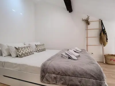 a white bed with two towels on top of it at Nestor&Jeeves - DUPLEX MIROIR - Hyper center - Shopping area - Top floor in Nice