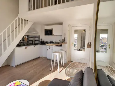 a living room and kitchen with a couch and chairs at Nestor&Jeeves - DUPLEX MIROIR - Hyper center - Shopping area - Top floor in Nice