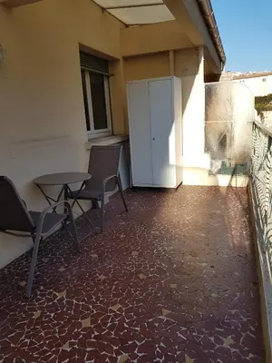 a patio with a table and chairs on a balcony at Sci MDM in Nice