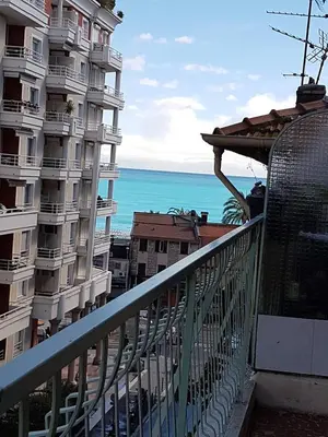 a balcony with a view of a building and the ocean at Sci MDM in Nice