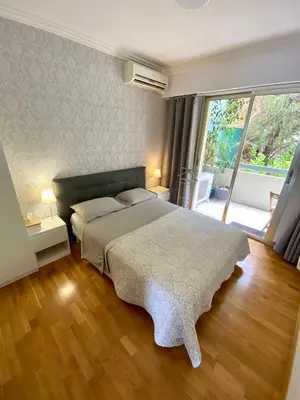 a bedroom with a large bed and a large window at Le Panomagique in Villefranche-sur-Mer
