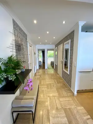 a hallway of a home with a bench and flowers at Le Panomagique in Villefranche-sur-Mer