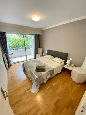 a bedroom with a bed and a large window at Le Panomagique in Villefranche-sur-Mer